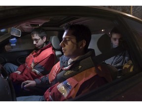 Emmanuel Caron (back seat) who'd called Operation Nez Rouge to drive him and his car home to Mascouche, and Nez Rouge volunteers Marc-André Tessier (right) and Alexander Leblanc prepare to leave the Plateau area of Montreal December 21, 2007. The Nez Rouge team included a third member who would follow the threesome to Mascouche then drive the team back to Monteal.