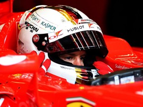 SPA, BELGIUM - AUGUST 21:  Sebastian Vettel of Germany and Ferrari sits in his car in the garage during practice for the Formula One Grand Prix of Belgium at Circuit de Spa-Francorchamps on August 21, 2015 in Spa, Belgium.