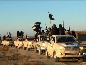 This file image posted on a militant website on Tuesday, Jan. 7, 2014, which is consistent with AP reporting, shows a convoy of vehicles and fighters from the al-Qaida linked Islamic State of Iraq and the Levant (ISIL) fighters in Iraq's Anbar Province.