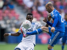 Montreal Impact's Laurent Ciman, right, controls the ball in front of Vancouver Whitecaps' Gershon Koffie, of Ghana, during first half Canadian Championship final soccer action in Vancouver, B.C., on Wednesday August 26, 2015.