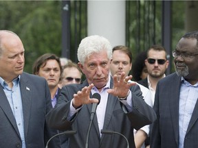 Bloc Quebecois leader Gilles Duceppe, centre, alongside MNA's Stephane Bergeron and Maka Kotto, right, speaks to supporters during a federal election campaign stop in Montreal, Monday, August 31, 2015.