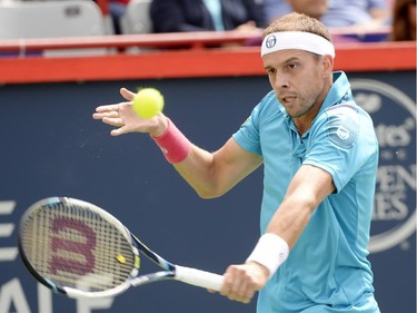 Gilles Muller, of Luxembourg, hits a return to Andy Murray, of Great Britain, during round of 16 tennis action at the Rogers Cup in Montreal on Thursday, August 13, 2015.