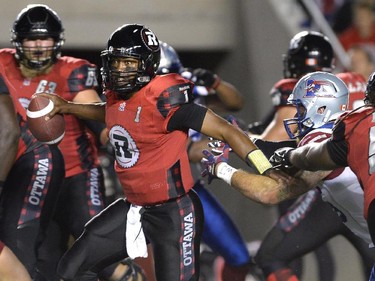 Ottawa Redblacks quarterback Henry Burris (1) plays looks downfield against the Montreal Alouettes during the first half of a CFL game in Ottawa on Friday, Aug. 7, 2015.