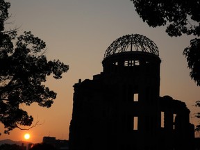 The sun sets behind the Atomic Bomb Dome at the Hiroshima Peace Memorial Park on the day before the 70th anniversary of the atomic bombing of Hiroshima on August 5, 2015 in Hiroshima, Japan.