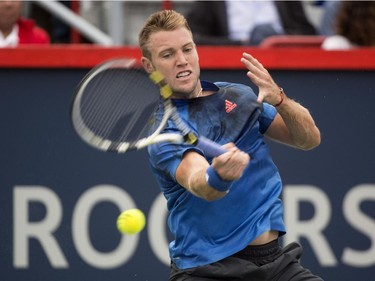 Jack Sock, of the United States, returns to Novak Djokovic, of Serbia, during round of sixteen play at the Rogers Cup tennis tournament Thursday August 13, 2015 in Montreal.