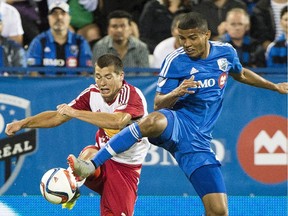 Red Bulls' Karl Ouimette, a former Impact defender battles Impact's Johan Venegas during MLS game in 2015. Ouimette, of Repentigny, was kicked from behind Saturday in a USL game, leading to a year-long ban for his attacker, Jamaican forward Romeo Parkes.