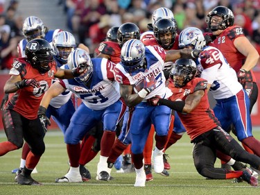 Ottawa Redblacks Jordan Verdone (33) tries to play the ball past the Montreal Alouettes during the first half of a CFL game in Ottawa on Friday, Aug. 7, 2015.