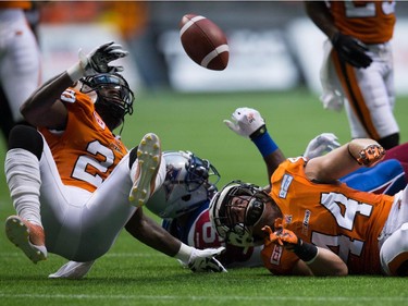 B.C. Lions' quarterback Greg McGhee (2) falls to the ground after Adam Bighill (44) tackled Montreal Alouettes' S.J. Green, back, during the first half of a CFL football game in Vancouver, B.C., on Thursday August 20, 2015.