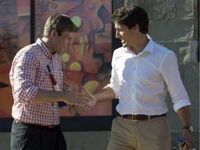 Federal Liberal leader Justin Trudeau is greeted by New Brunswick Premier Brian Gallant, left, as he campaigns in the riding of Acadie-Bathurst Saturday, August 15, 2015.