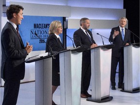 Liberal leader Justin Trudeau, Green Party leader Elizabeth May and New Democratic Party leader Thomas Mulcair listen as Conservative Leader Stephen Harper take part in the first leaders debate Thursday, August 6, 2015 in Toronto.