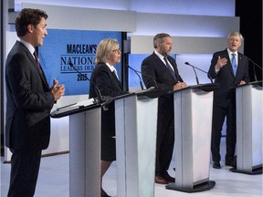 Liberal leader Justin Trudeau, Green Party leader Elizabeth May and New Democratic Party leader Thomas Mulcair listen as  Conservative Leader Stephen Harper take part in the first leaders debate Thursday, August 6, 2015 in Toronto.