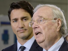 Liberal Leader Justin Trudeau, left, looks on as former prime minister Paul Martin speaks to supporters during a campaign stop in Toronto on Tuesday, August 25, 2015.