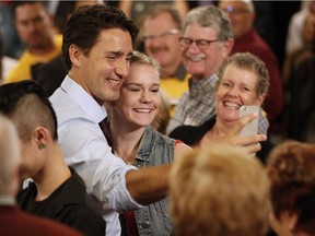 Liberal leader Justin Trudeau poses for a selfie with a supporter during a campaign stop in Winnipeg Wednesday, Aug. 19, 2015.