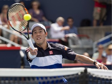 Kei Nishikori of Japan goes up to the net to return to Pablo Andujar of Spain during second round of play at the Rogers Cup tennis tournament Wednesday August 12, 2015 in Montreal.