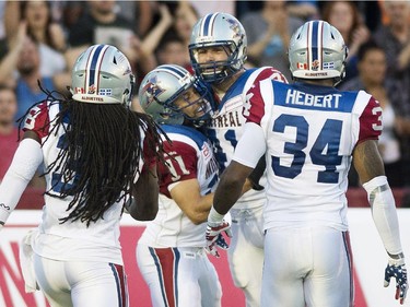 Montreal Alouettes' Kyler Elsworth (41) celebrates with teammates Dominique Ellis (38), Chip Cox (11) and Kyries Hebert (34) after scoring a touchdown against the Edmonton Eskimos during first half CFL football action against the Montreal Alouettes in Montreal, Thursday, August 13, 2015.
