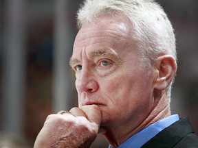 San Jose Sharks associate coach Larry Robinson behind his team's bench in Vancouver during the 2013-14 season.