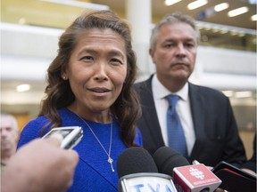 Lu Chan Khuong, the suspended head of the Quebec Bar association, speaks to reporters as she arrives at the courthouse with her lawyer Jean-Francois Bertrand Thursday, August 20, 2015 in Quebec City.