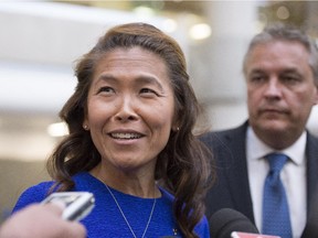 Lu Chan Khuong, the suspended head of the Quebec Bar association, arrives at the courthouse with her lawyer Jean-François Bertrand Thursday  in Quebec City.