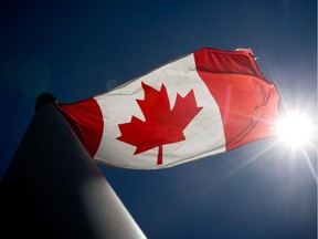 A Canadian flag flies in the wind.
