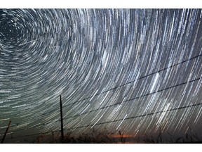 Meteors streak above the Wyoming countryside.