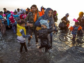 Migrants arrive at at the southeastern island of Kos, Greece at sunrise, early Saturday, Aug. 15, 2015. The International Organization for Migration said the number of migrants and asylum-seekers who have crossed the Mediterranean to Europe this year will pass the quarter-million mark by the end of the month, more than half of them arriving in Greece.