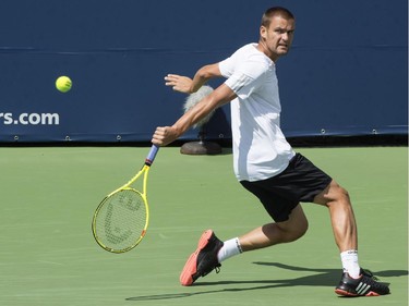 Mikhail Youzhny of Russia returns to Gilles Simon from France during second round of play at the Rogers Cup tennis tournament Wednesday August 12, 2015 in Montreal.