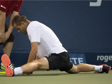 Mikhail Youzhny of Russia does the splits after trying to reach a return from Rafael Nadal of Spain during round of sixteen play at the Rogers Cup tennis tournament Thursday August 13, 2015 in Montreal.