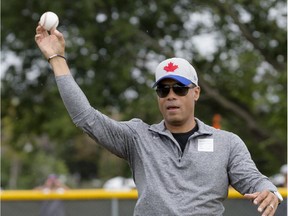 Hall of Famer and former Toronto Blue Jay Robbie Alomar throws the ceremonial first pitch at the Canadian Little League Championship in Ottawa on Aug. 13, 2015.