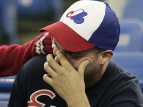 Sébastien Potvin is comforted by his girlfriend, Isabelle Bélanger, as he cries before the start of the Expos final game at Olympic Stadium in Montreal on Sept. 29 2004.