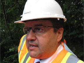Montreal Mayor Denis Coderre addresses media following his use of a jackhammer to destroy a concrete foundation, which was laid for an unauthorized community mailbox at the entrance to Anse-a-l'Orme Nature Park, in Montreal, on Thursday, August 13, 2015.