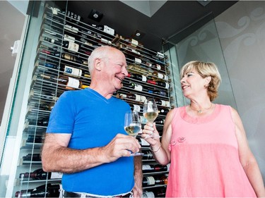 Richard Blais and Line Brochu  have a toast in front of their precious wine rack.