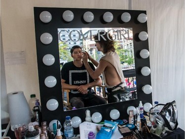 A make-up artist does a few touch-ups on a male model, on Wednesday August 19, 2015, at the Festival Mode and Design, in Montreal.