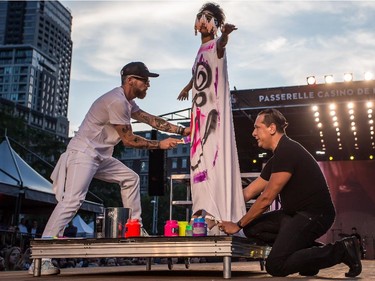Annie Pigeon from the band APigeon gets her dress painted by Scooter LaForge during the group's performance, on Wednesday August 19, 2015, at the Festival Mode and Design, in Montreal.