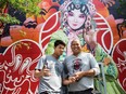 Bryan Beyung (left) and Gene Pendon (right) pose for a photo in front of their new mural at the Chinatown gate, on Monday August 24, 2015, in Montreal.