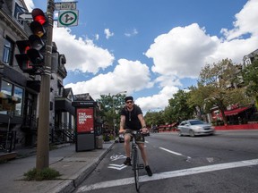 Aurelien Gallard rides his bicycle on the new Saint-Denis bike path, on Wednesday Aug. 26, 2015, in Montreal.