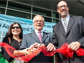 Dorval Mayor Edgar Rouleau (centre), president of the Commission scolaire Marguerite-Bourgeoys Diane Lamarche-Venne (left) and Marquette MNA François Ouimet (right), cut the ribbon at the opening ceremony for the new Dorval Aquatic and Sports Complex, on Friday, Aug. 28, 2015.