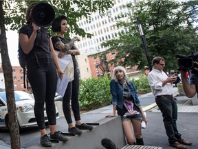 Fannie Gadouas (left) talks about consent and rape culture, while Catherine Hotte (centre) and Aurelie Nix (right) listen, at Norman Bethune Square, during the anti-rape culture demonstration, in Montreal, Quebec, on Saturday, August 8, 2015. They all are anti-rape culture activists and organizers of the anti-rape culture demonstration.