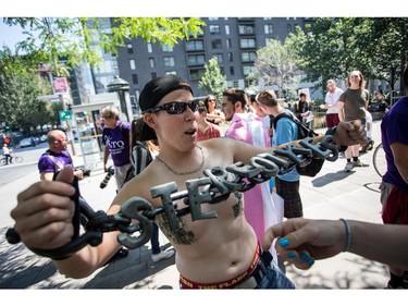 MONTREAL, QC.: AUGUST 9, 2015 -- Vincent-Gabriel Lamarre flaunts his "stereotypes chain" at the Montreal Trans March 2015, at Place-des-Arts, in Montreal, Quebec on Sunday August 9, 2015. (Giovanni Capriotti / MONTREAL GAZETTE)
