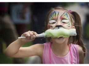 MarieAnge Legault of St Zotique enjoys cotton candy at the Hudson Quebec street festival in 2015.
