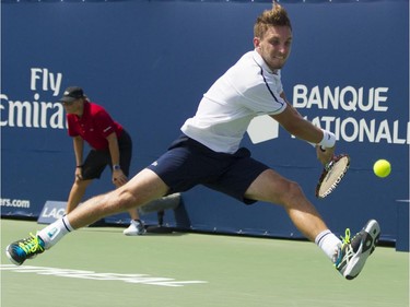 Canadian tennis player Filip Peliwo stretches to make a return shot against Sergiy Stakhovsky of the Ukraine at the Rogers Cup at Jarry Tennis stadium Monday, August 10, 2015. Stakhovsky won the match.