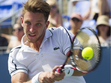 Canadian tennis player Filip Peliwo makes a return shot against Sergiy Stakhovsky of the Ukraine at the Rogers Cup at Jarry Tennis stadium Monday, August 10, 2015. Stakhovsky won the match.