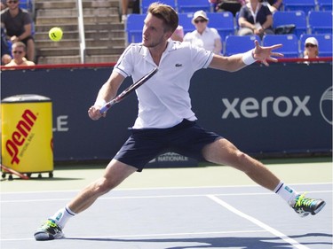 Canadian tennis player Filip Peliwo stretches to return a shot against Sergiy Stakhovsky of the Ukraine at the Rogers Cup at Jarry Tennis stadium Monday, August 10, 2015. Stakhovsky won the match.