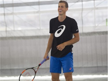 Canadian tennis star Vasek Pospisil has a laugh with the Montreal Gazette's Pat Hickey Monday, August 10, 2015 during an exhibition at the Rogers Cup at Jarry tennis stadium.