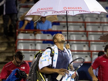 Jo-Wilfred Tsonga (FRA) looks up at the sky as he leaves the court for a rain delay during his match against Borna Coric (CRO) during Rogers Cup action in Montreal on Monday August 10, 2015.