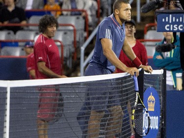 Jo-Wilfred Tsonga (FRA) waits as officials decide to call off his match against Borna Coric (CRO) during Rogers Cup action in Montreal on Monday August 10, 2015.