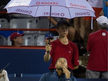 Jo-Wilfred Tsonga (FRA) watches the rain fall during a second rain delay during his match against Borna Coric (CRO)  during Rogers Cup action in Montreal on Monday August 10, 2015.