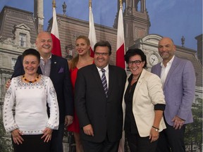Mayor Denis Coderre (C) and Eric Pineault (2nd L), president of Fierte Montreal pose with The Grand Marshals of Montreal's pride week after a signing the city's Livre d'Or at City Hall in Montreal, August 10, 2015. From L-R: Anna Sharyhina, director KyivPride, Ukraine, Eric Pineault, president Fierte Montreal,   Candis Cayne, American actress, Mayor Denis Coderre, Monique Giroux, Quebec radio host and producer, and Richard Montoro, McGill University psychiatrist.