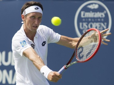 Sergiy Stakhovsky of the Ukraine makes a return shot against Canadian tennis player Filip Peliwo at the Rogers Cup at Jarry Tennis stadium Monday, August 10, 2015. Stakhovsky won the match.