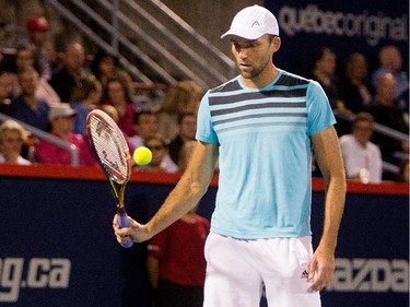 Ivo Karlovic (CRO) plays with the ball as he waits for noisy fans to take their seats during his match against Milos Raonic (CAN) during Rogers Cup action in Montreal on Tuesday August 11, 2015.