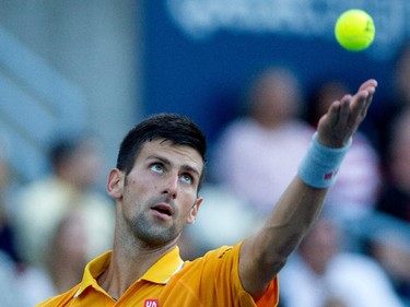 Novak Djokovic (SRB) serves the ball to Thomaz Bellucci (BRA) during Rogers Cup action in Montreal on Tuesday August 11, 2015.